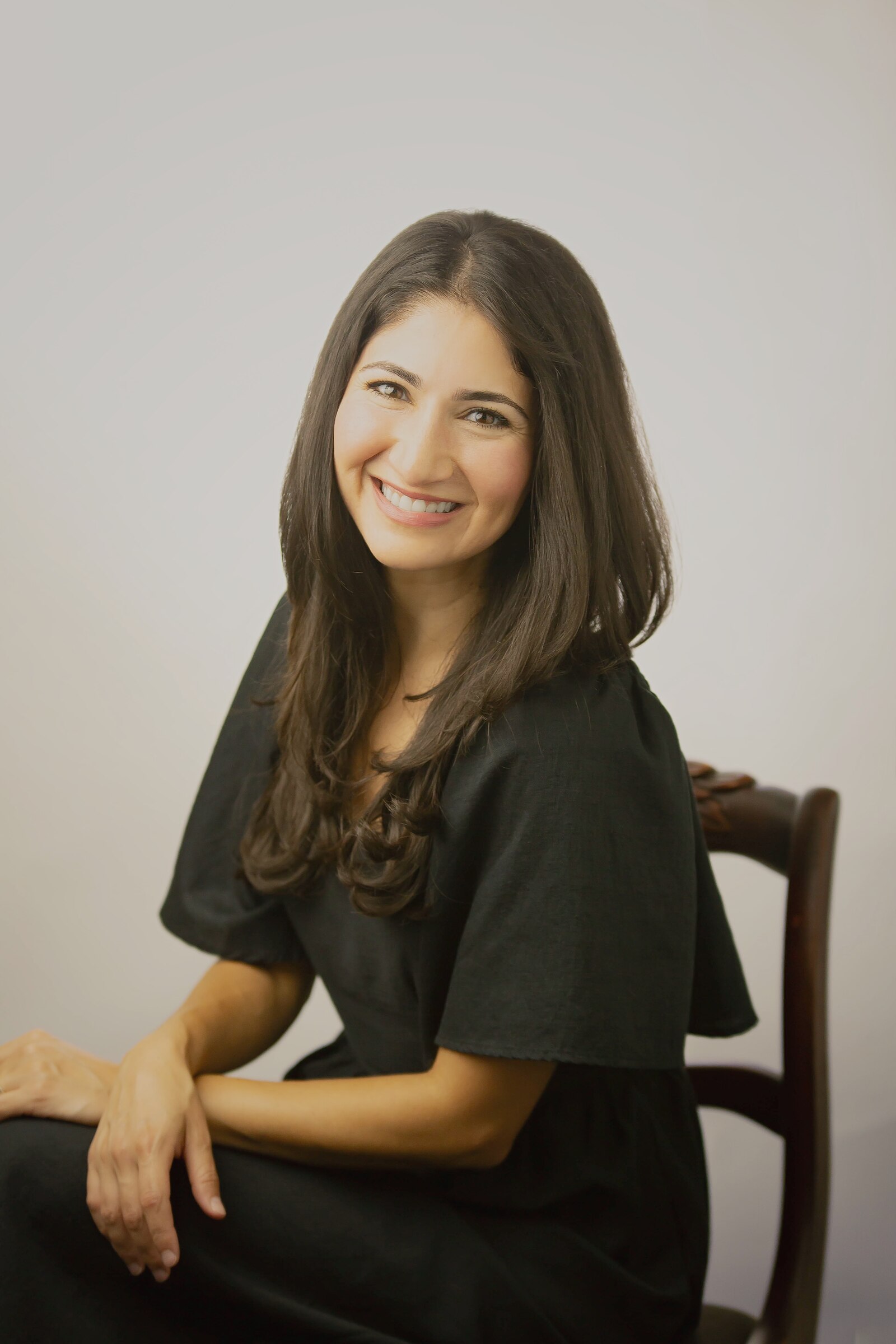 Noelle Harb Brundige, seated studio portrait